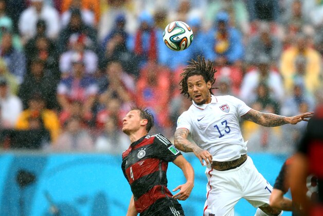 Jun 26, 2014; Recife, BRAZIL; USA midfielder Jermaine Jones (13) heads the ball against Germany defender Benedikt Howedes (4) during the 2014 World Cup at Arena Pernambuco. Germany defeated USA 1-0. Mandatory Credit: Mark J. Rebilas-USA TODAY Sports
