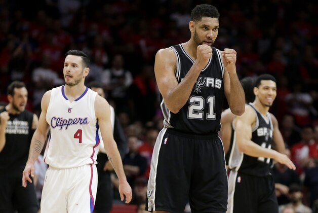 San Antonio Spurs forward Tim Duncan, right, celebrates a basket as Los Angeles Clippers guard J.J. Redick walks by  during the second half of Game 2 of a first-round NBA basketball playoff series in Los Angeles, Wednesday, April 22, 2015. The Spurs won 111-107 in overtime. (AP Photo/Chris Carlson)
