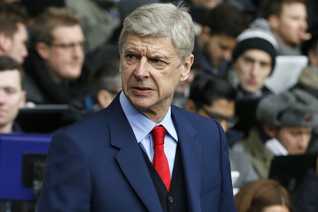 Arsenal's head coach Arsene Wenger stands on the touchline before the English Premier League soccer match between Tottenham Hotspur and Arsenal at the White Hart Lane stadium in London, Saturday, Feb. 7, 2015. (AP Photo/Alastair Grant)