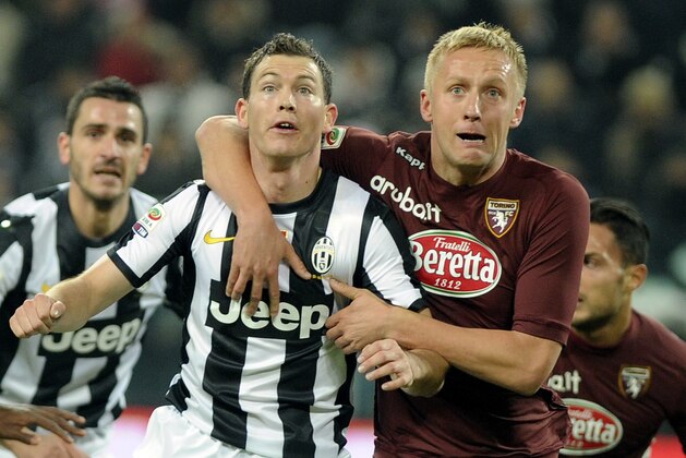 Juventus Swiss defender Stephan Lichtsteiner, left, vies with Torino's Kamil Glik, of Poland, during a Serie A soccer match at the Juventus Stadium in Turin, Italy, Saturday, Dec 1, 2012. (AP Photo/Massimo Pinca)