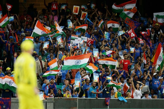 Indian supporters wave their flags as they cheer their team during their Cricket World Cup semifinal against Australia in Sydney, Australia, Thursday, March 26, 2015. (AP Photo/Rob Griffith)