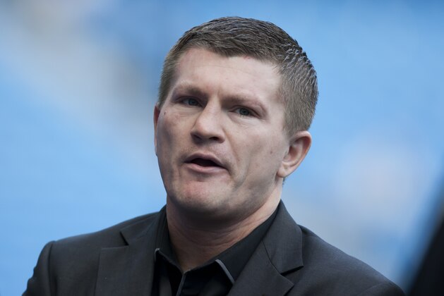 Boxer Ricky Hatton stands by the pitch before Manchester City's English Premier League soccer match against Manchester United at the Etihad Stadium, Manchester, England, Sunday Sept. 22, 2013. (AP Photo/Jon Super)