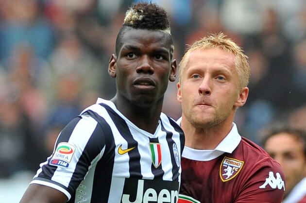 Juventus midfielder Paul Pogba, of France, and Torino defender Kamil Glik, of Poland, look at the ball, during a Serie A soccer match between Torino and Juventus at the Olympic stadium, in Turin, Italy, Sunday, Sept. 29, 2013. (AP Photo/Massimo Pinca)