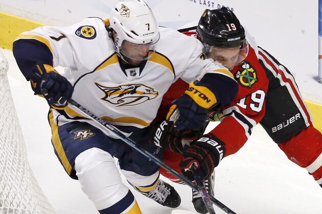 Nashville Predators center Matt Cullen (7) and Chicago Blackhawks center Jonathan Toews (19) battle for position during the first overtime in Game 4 of an NHL Western Conference hockey playoff series Tuesday, April 21, 2015, in Chicago. (AP Photo/Charles Rex Arbogast)
