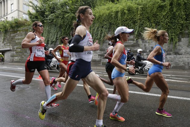 France's Christelle Daunay, center, runs in the women's marathon during the European Athletics Championships in Zurich, Switzerland, Saturday, Aug. 16, 2014. (AP Photo/Petr David Josek)