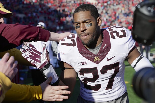 Minnesota running back David Cobb (27) celebrates with fans following an NCAA college football game against Nebraska in Lincoln, Neb., Saturday, Nov. 22, 2014. Minnesota won 28-24. (AP Photo/Nati Harnik)