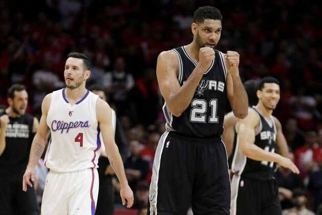 San Antonio Spurs forward Tim Duncan, right, celebrates a basket as Los Angeles Clippers guard J.J. Redick walks by  during the second half of Game 2 of a first-round NBA basketball playoff series in Los Angeles, Wednesday, April 22, 2015. The Spurs won 111-107 in overtime. (AP Photo/Chris Carlson)
