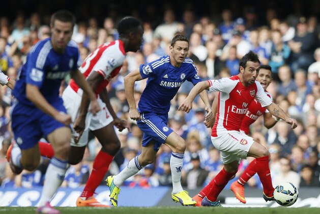 Arsenal's Santi Cazorla takes the ball forward during their English Premier League soccer match between Chelsea and Arsenal at Stamford Bridge stadium in London Sunday, Oct. 5, 2014. (AP Photo/Alastair Grant)