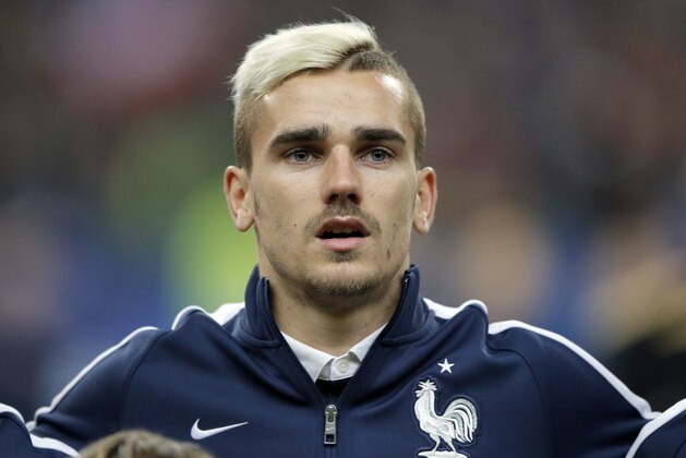 France’s Antoine Griezmann stands for the national anthem prior to the international friendly soccer match between France and Brazil at the Stade de France, north of Paris, France, Thursday, March 26, 2015. (AP Photo/Francois Mori)