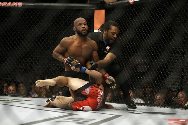 Demetrious Johnson, left, pins Chris Cariaso during their main event fight, Saturday, Sept. 27, 2014, in Las Vegas. Johnson won via submission. (AP Photo/John Locher)