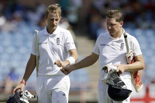 England's batsmen Joe Root, left, and England's Gary Ballance compliment each other as they leave the field for atea break on the third day of their second Test match against West Indies at the National Stadium in St. George's, Grenada, Thursday, April 23, 2015. (AP Photo/Ricardo Mazalan)