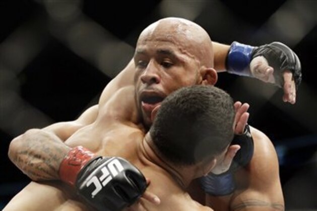 Demetrious Johnson, right, fights John Dodson during UFC  flyweight championship at the United Center in Chicago, Saturday, Jan. 26, 2013. (AP Photo/Nam Y. Huh)