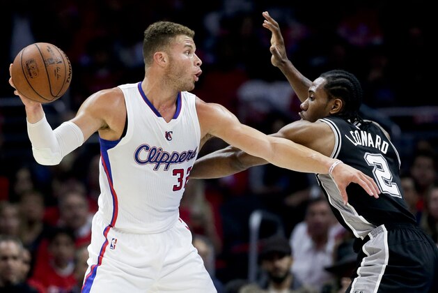 Los Angeles Clippers forward Blake Griffin, left, passes around San Antonio Spurs forward Kawhi Leonard during Game 2 of a first-round NBA basketball playoff series in Los Angeles, Thursday, April 23, 2015. The Spurs won 111-107 in overtime. (AP Photo/Chris Carlson)