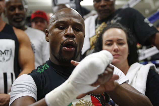 Boxer Floyd Mayweather Jr. gets taped up before a workout Tuesday, April 14, 2015, in Las Vegas. Mayweather will face Manny Pacquiao in a welterweight boxing match in Las Vegas on May 2. (AP Photo/John Locher)