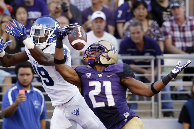 Washington's Marcus Peters (21) snags the ball in the end zone in front of intended receiver Georgia State's Robert Davis in the first half of an NCAA college football game Saturday, Sept. 20, 2014, in Seattle. Peters was flagged for pass interference on the play, leading to a Georgia State touchdown on the drive. (AP Photo/Elaine Thompson)