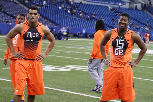 Feb 21, 2015; Indianapolis, IN, USA; Florida State Seminoles quarterback Jameis Winston and Oregon Ducks quarterback Marcus Mariota watch drills during the 2015 NFL Combine at Lucas Oil Stadium. Mandatory Credit: Brian Spurlock-USA TODAY Sports