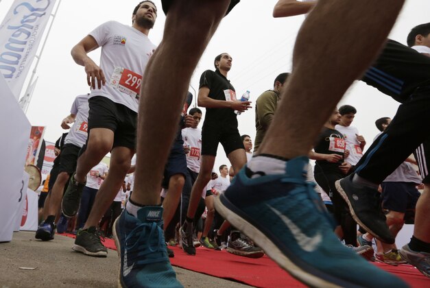 In this Friday, April 17, 2015 photo, Egyptian runners participate in Cairo's annual Half Marathon in the Heliopolis district in Cairo, Egypt, Friday, April 17, 2015. Cairo, a city of some 20 million people packed onto the banks of the Nile, with few green spaces and no jogging paths, is an unlikely venue for distance running. (AP Photo/Amr Nabil)