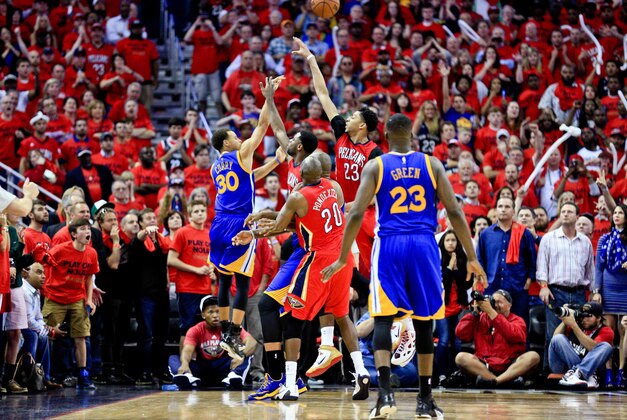 Apr 23, 2015; New Orleans, LA, USA; Golden State Warriors guard Stephen Curry (30) scores on a three point basket over New Orleans Pelicans guard Tyreke Evans (1) and forward Anthony Davis (23) and guard Quincy Pondexter (20) during the final seconds of the fourth quarter sending the game into overtime in game three of the first round of the NBA Playoffs at  the Smoothie King Center. The Warriors defeated the Pelicans 123-119 in overtime. Mandatory Credit: Derick E. Hingle-USA TODAY Sports