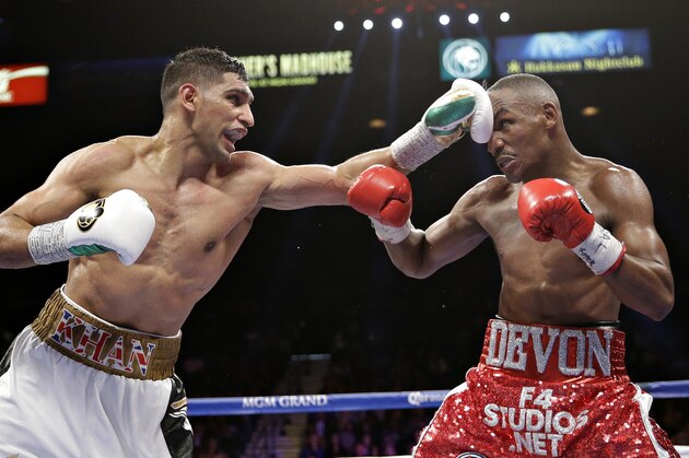 Amir Khan punches Devon Alexander during their welterweight bout Saturday, Dec. 13, 2014, in Las Vegas. (AP Photo/John Locher)