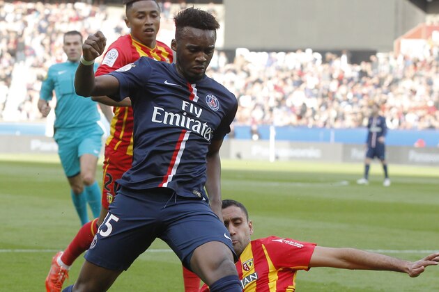PSG's Jean-Christophe Bahebeck, left, and Lens Ahmed Kantari, right, challenge for the ball during a League One soccer match Paris Saint Germain against Lens at Parc des Prince stadium in Paris, France, Saturday, March 7, 2015. Paris Saint Germain won 4-1. (AP Photo/Michel Euler)