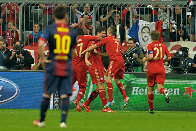 Barcelona forward Lionel Messi, of Argentina,  looks at Bayern players celebrate after Mario Gomez, third right, scored during the Champions League semifinal first leg soccer match between Bayern Munich and FC Barcelona in Munich, Germany, Tuesday, April 23, 2013. (AP Photo/Kerstin Joensson)