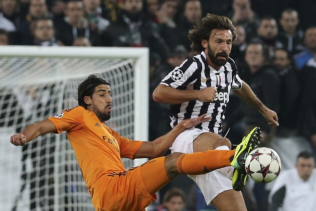 Real's Sami Khedira, left, challenges Juventus' Andrea Pirlo during a Champions League, Group B, soccer match between Juventus and Real Madrid at the Juventus stadium in Turin, Italy, Tuesday, Nov. 5, 2013. (AP Photo/Antonio Calanni)