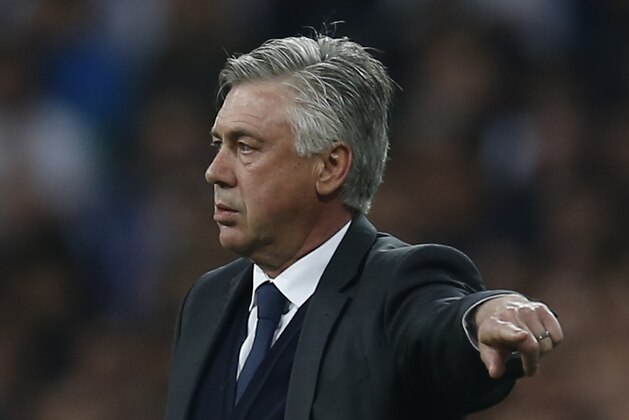 Real Madrid's coach Carlo Ancelotti gives directions to his players during the second leg quarterfinal Champions League soccer match between Real Madrid and Atletico Madrid at Santiago Bernabeu stadium in Madrid, Spain, Wednesday April 22, 2015. (AP Photo/Paul White)