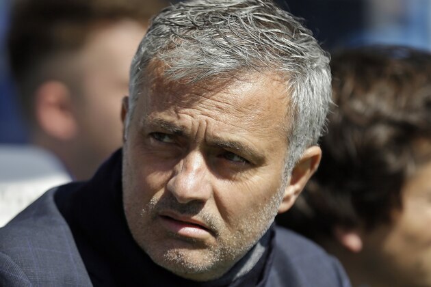 Chelsea's Chelsea manager Jose Mourinho takes his seat on the bench before the English Premier League soccer match between QPR and Chelsea at Loftus Road stadium in London, Sunday, April 12, 2015. (AP Photo/Matt Dunham)