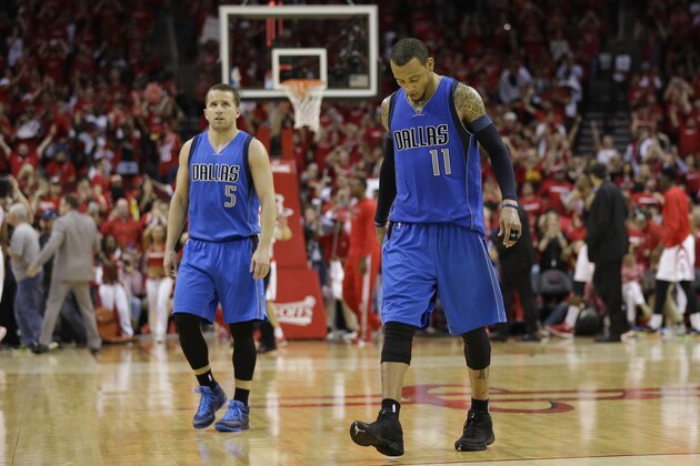 Dallas Mavericks' J.J. Barea (5) and Monta Ellis (11) walk off the court after their loss to the Houston Rockets in game 1 in the first round of the NBA basketball playoffs Saturday, April 18, 2015, in Houston. Houston won 118-108. (AP Photo/David J. Phillip)