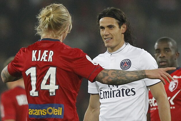 Lille's Simon Kjaer, left, and PSG's Edinson Cavani talk during their French League one soccer match at the Lille Metropole stadium, in Villeneuve d'Ascq, northern France, Wednesday, Dec. 3, 2014. (AP Photo/Michel Spingler)