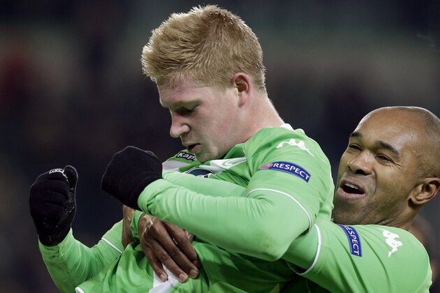 Wolfsburg's scorer Kevin De Bruyne, left, and his teammate Naldo celebrate their side's third goal during the Europa League round of sixteen first leg soccer match between VfL Wolfsburg and FC Internazionale Milano in Wolfsburg, Germany, Thursday, March 12, 2015. (AP Photo/Michael Sohn)