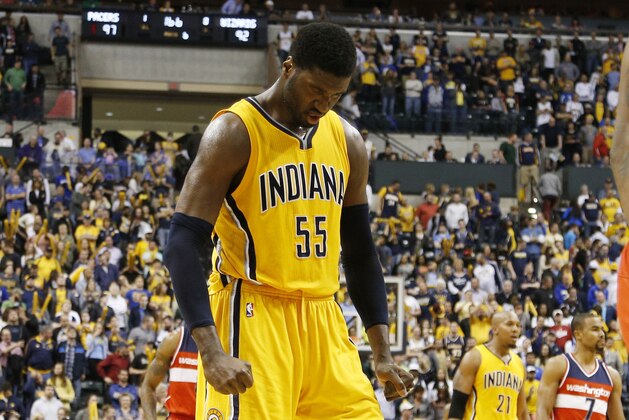 Apr 14, 2015; Indianapolis, IN, USA; Indiana Pacers center Roy Hibbert (55) flexes with 16 seconds to go in the second overtime as Washington Wizards center Kevin Seraphin (13) looks up at the scoreboard at Bankers Life Fieldhouse. Indiana defeats Washington 99-95 in double overtime. Mandatory Credit: Brian Spurlock-USA TODAY Sports
