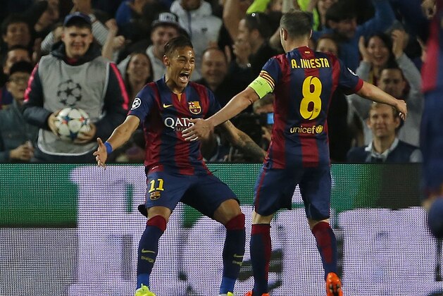 Barcelona's Neymar, left, celebrates with Andres Iniesta after scoring the opening goal during the Champions League quarterfinal second leg soccer match between FC Barcelona and Paris Saint Germain at the Camp Nou Stadium in Barcelona, Spain, Tuesday, April 21, 2015. (AP Photo/Emilio Morenatti)