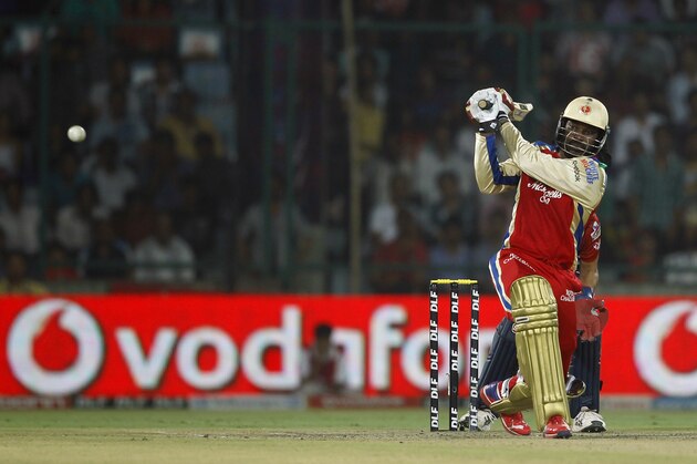 Chris Gayle of Royal Challengers Bangalore plays a shot on his way to scoring a century during their IPL cricket match against Delhi Daredevils, in New Delhi, India, Thursday, May 17, 2012. (AP Photo/ Saurabh Das)