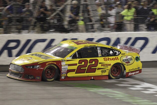 Joey Logano crosses the finish line to win the NASCAR Sprint Cup auto race at Richmond International Raceway in Richmond, Va., Saturday, April 26, 2014. (AP Photo/Steve Helber)