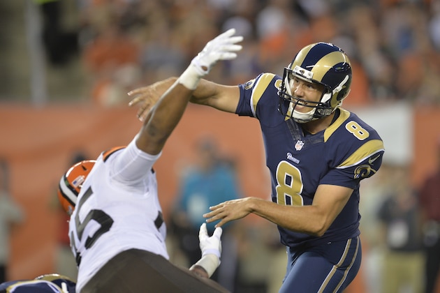 St. Louis Rams quarterback Sam Bradford is hit by Cleveland Browns defensive end Armonty Bryant (95) in the first quarter of a preseason NFL football game Saturday, Aug. 23, 2014, in Cleveland. Bradford left the game and was taken to the locker room after the play. St. Louis won 33-14. (AP Photo/David Richard)