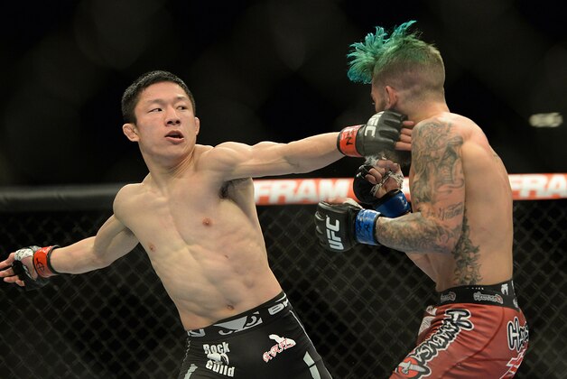 Jan 3, 2015; Las Vegas, NV, USA; Kyoji Horiguchi (red gloves) and Louis Gaudinot (blue gloves) compete in their flyweight bout at UFC 182 at MGM Grand Garden Arena. Mandatory Credit: Jayne Kamin-Oncea-USA TODAY Sports