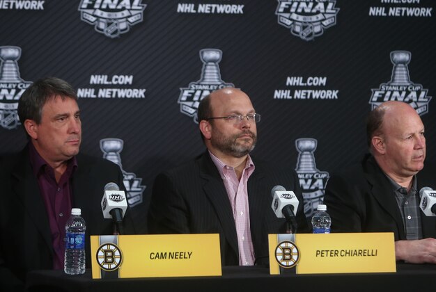 Jun 11, 2013; Chicago, IL, USA; Boston Bruins head coach Claude Julien (right) , general manager Peter Chiarelli (middle) and president Cam Neely are interviewed during media day in preparation for game one of the 2013 Stanley Cup Final against the Chicago Blackhawks at the United Center. Mandatory Credit: Jerry Lai-USA TODAY Sports