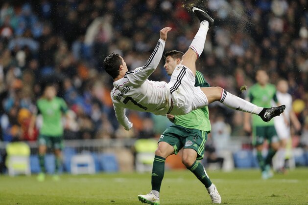 Real Madrid's Cristiano Ronaldo jumps during a Spanish La Liga soccer match between Real Madrid and Celta de Vigo at the Bernabeu stadium in Madrid, Spain, Saturday, Dec. 6, 2014 . (AP Photo/Daniel Ochoa de Olza)