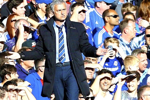 Chelsea manager Jose Mourinho grimaces before before the Champions League round of 16 second leg soccer match between Chelsea and Paris Saint Germain at Stamford Bridge stadium in London, Wednesday, March 11, 2015. (AP Photo/Matt Dunham)