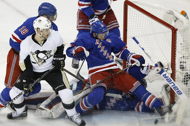 New York Rangers center Derek Stepan (21) helps goalie Henrik Lundqvist (30) defend against the Pittsburgh Penguins in the second period of Game 5 during the first round of the NHL hockey Stanley Cup playoffs, Friday, April 24, 2015, in New York. (AP Photo/Julie Jacobson)