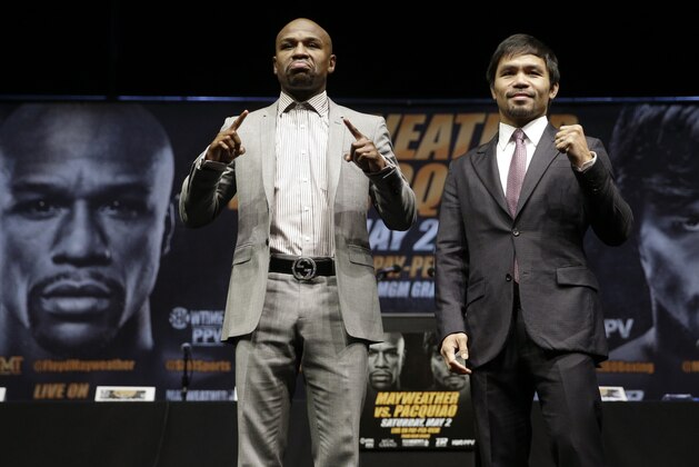 ADVANCE FOR WEEKEND EDITIONS, APRIL 25-26 - FILE - In this March 11, 2015, file photo, boxers Floyd Mayweather Jr., left, and Manny Pacquiao, of the Philippines, pose for photos after a news conference in Los Angeles. This is not Hagler-Hearns or Tyson vs. Anyone. Floyd Mayweather Jr. is the greatest defensive boxer in history, and Manny Pacquiao hasn't shown knockout power in a while. Expect this fight to go to the scorecards. (AP Photo/Jae C. Hong, File)