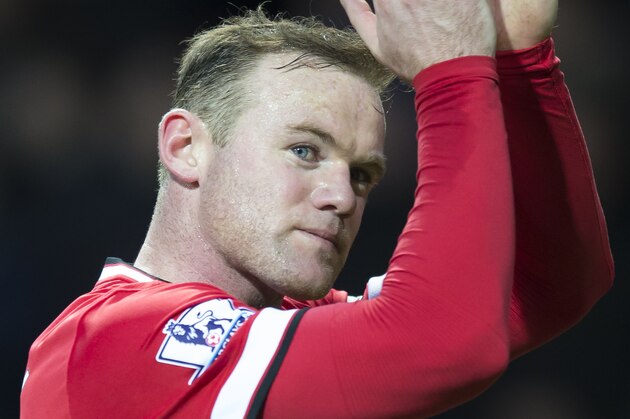 Manchester United's Wayne Rooney applauds supporters after the English Premier League soccer match between Manchester United and Tottenham Hotspur at Old Trafford Stadium, Manchester, England, Sunday March 15, 2015. (AP Photo/Jon Super)