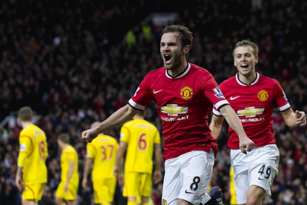 Manchester United's Juan Mata celebrates after scoring during the English Premier League soccer match between Manchester United and Liverpool at Old Trafford Stadium, Manchester, England, Sunday Dec. 14, 2014. (AP Photo/Jon Super)
