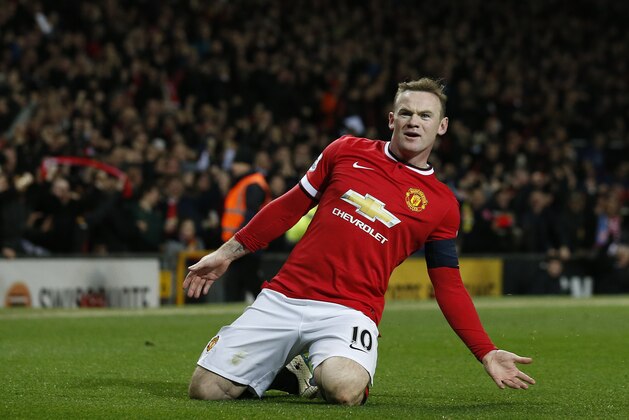 Manchester United’s Wayne Rooney celebrates after scoring the opening goal of the game during the English FA Cup quarterfinal soccer match between Manchester United and Arsenal at Old Trafford Stadium, Manchester, England, Monday, March 9, 2015. (AP Photo/Jon Super)