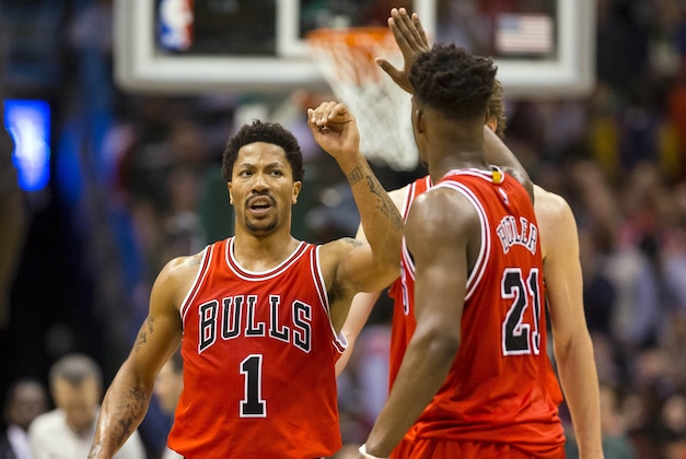 Apr 23, 2015; Milwaukee, WI, USA; Chicago Bulls guard Derrick Rose (1) is greeted by Chicago Bulls guard Jimmy Butler (21) after scoring during the second overtime period against the Milwaukee Bucks in game three of the first round of the NBA Playoffs at BMO Harris Bradley Center. Mandatory Credit: Jeff Hanisch-USA TODAY Sports