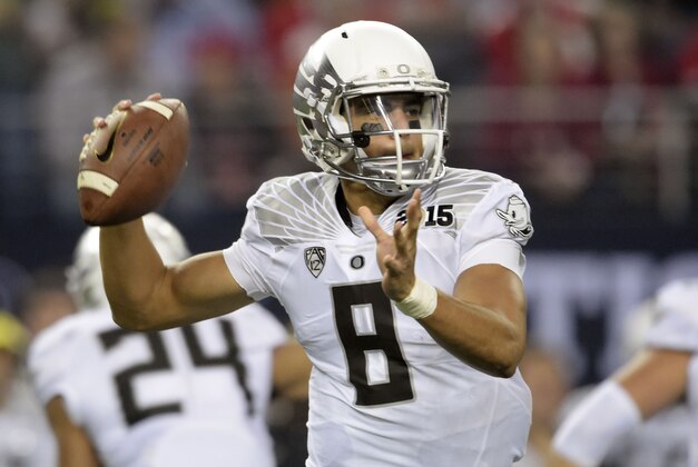 Jan 12, 2015; Arlington, TX, USA; Oregon Ducks quarterback Marcus Mariota (8) looks to pass during the first quarter against the Ohio State Buckeyes in the 2015 CFP National Championship Game at AT&T Stadium. Mandatory Credit: Kirby Lee-USA TODAY Sports