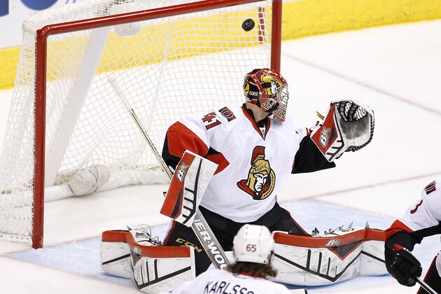 Ottawa Senators' Craig Anderson watches the puck get past him on a shot by the Arizona Coyotes during the second period of an NHL hockey game Saturday, Jan. 10, 2015, in Glendale, Ariz.  The puck did not go into the net but instead it bounced around the front along the goal line. (AP Photo/Ross D. Franklin)
