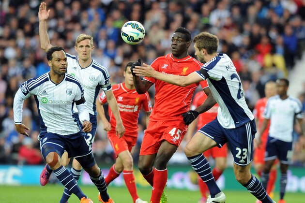 Liverpool's Mario Balotelli, middle, attempts to break through West Brom's Gareth McAuley, right, and Joleon Lescott, left,  during the English Premier League soccer match between West Bromwich Albion and Liverpool at the Hawthorns, West Bromwich, England, Saturday, April 25, 2015. (AP Photo/Rui Vieira)