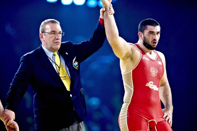 Russia's Bilyal Makhov, right, celebrates after defeating Iran's Fardin Masoumi Valadi in the 120 kilo freestyle class during the wrestling world championships finals in Herning, Denmark, Tuesday, Sept. 22, 2009. (AP Photo/POLFOTO, Claus Bonnerup)  **  DENMARK OUT  **